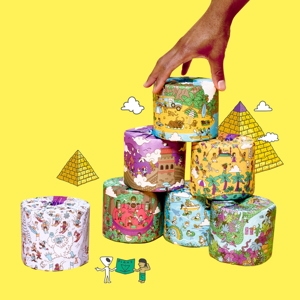 Stack of colourful wrapped toilet paper rolls with a hand arranging them on a yellow background