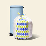 Who Gives a Crap large recycled trash bag sits full next to kitchen bin