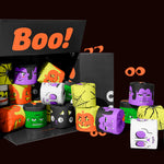 Open black box packed with Halloween-printed bamboo toilet paper rolls in orange, purple, green and white. Box reads 
